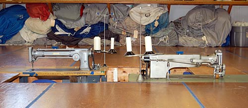 Photo of long arm sewing machines in machine pits.